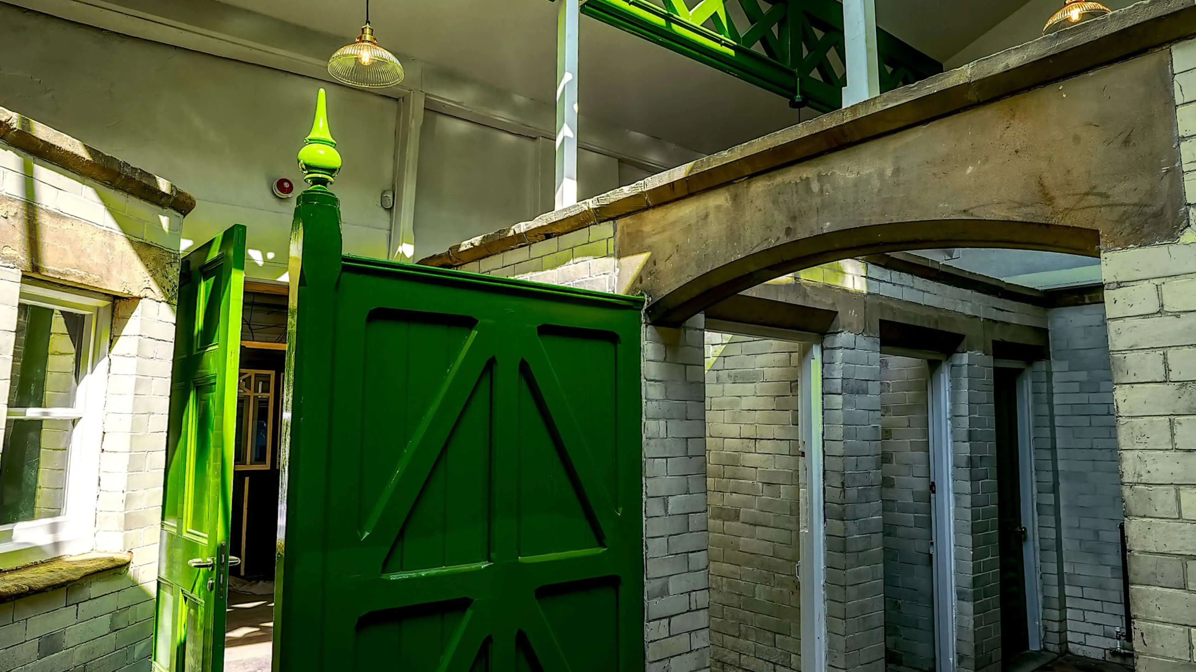 Old brick Victorian toilet block with green wooden features