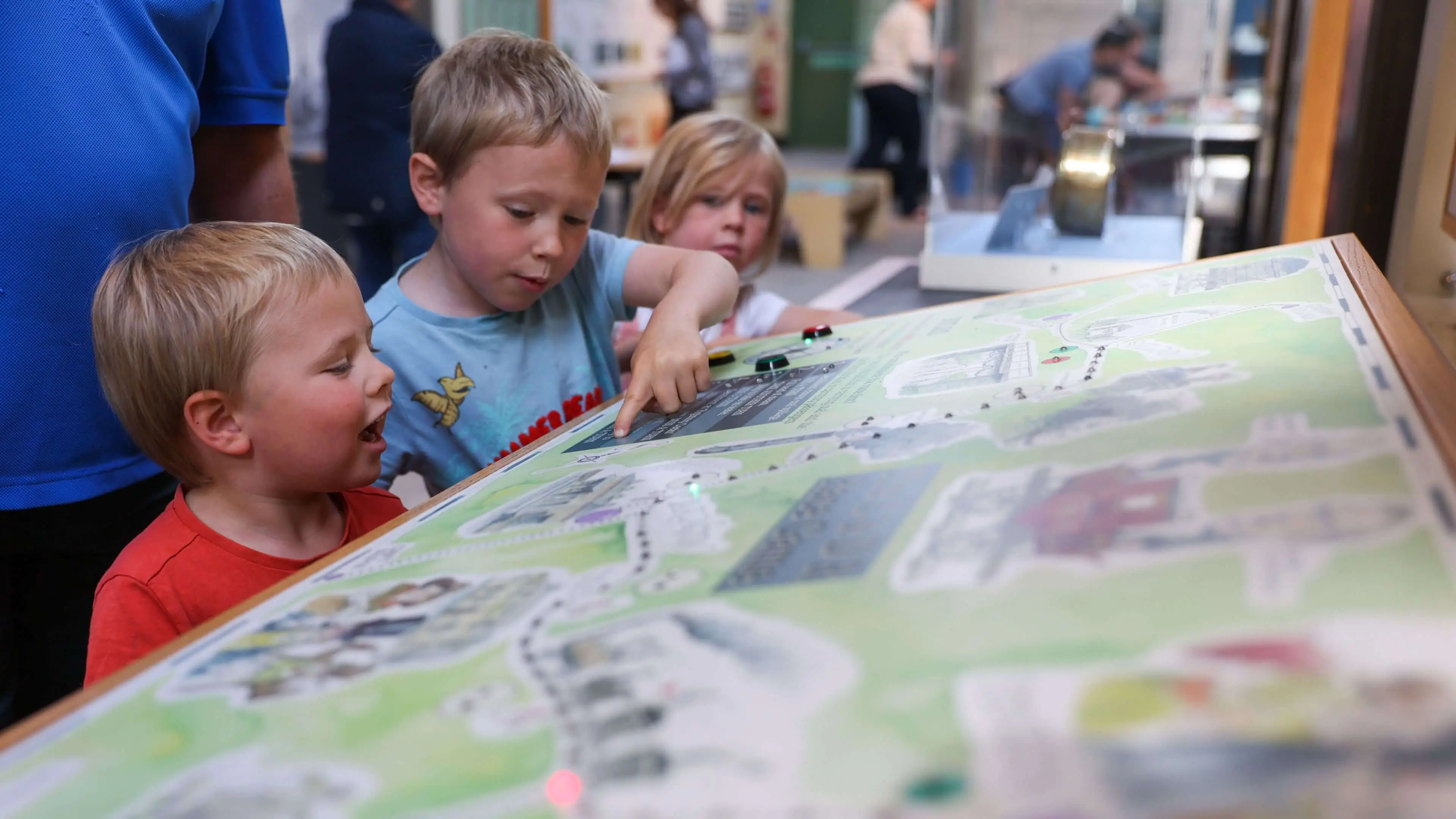 A group of children interacting with a railway feature