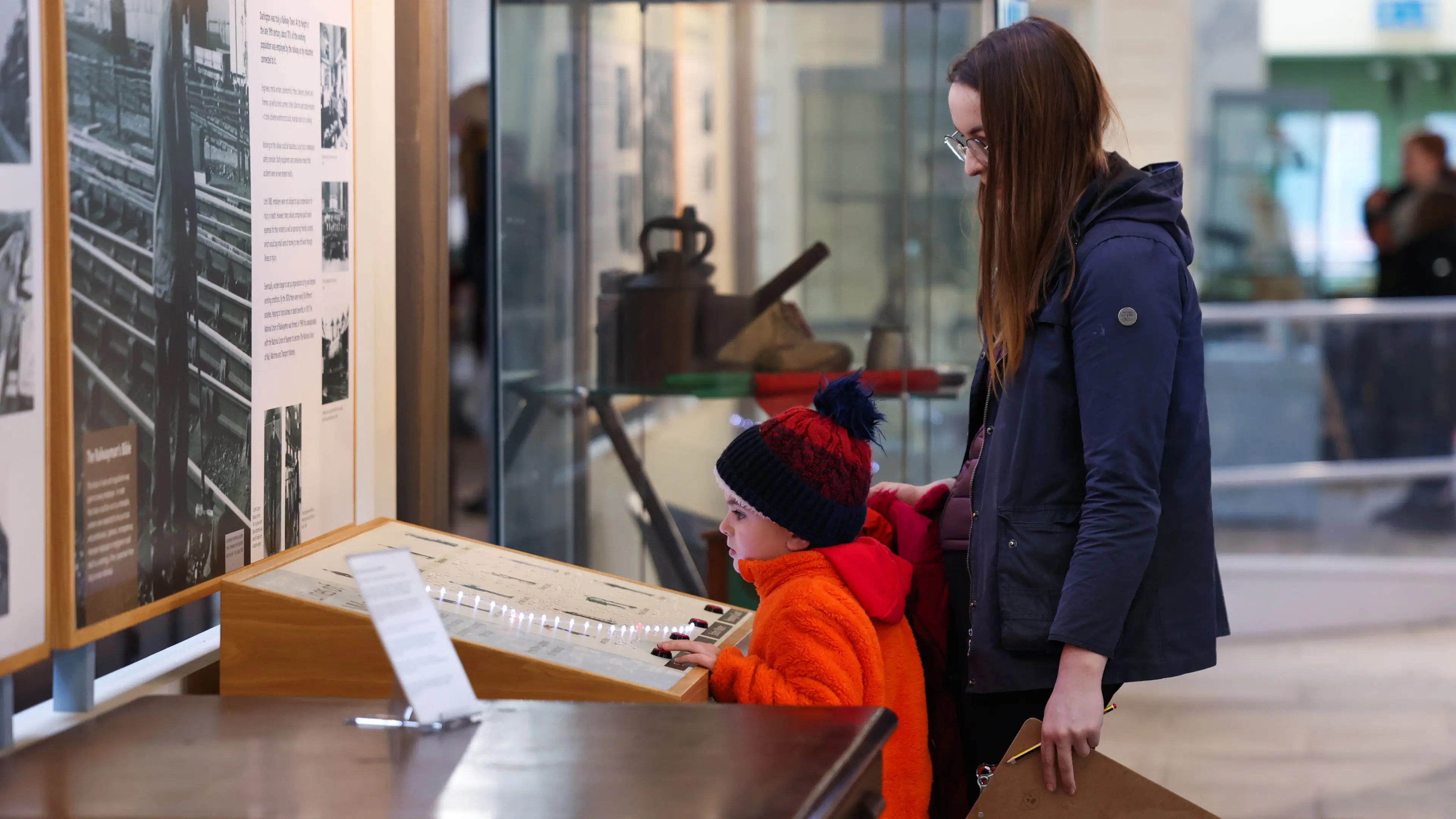Mother and child interacting with museum display